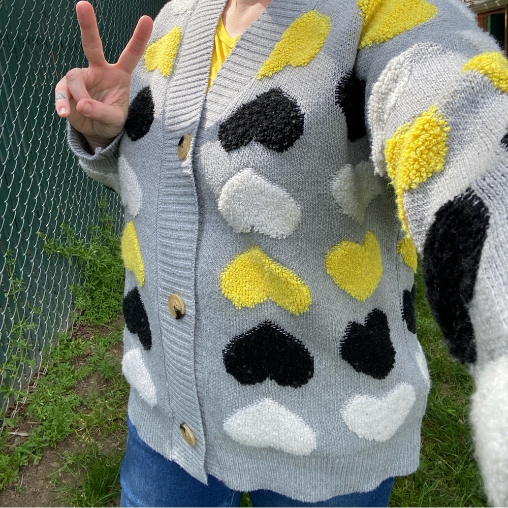 Gray button up cardigan sweater with plush heart pattern